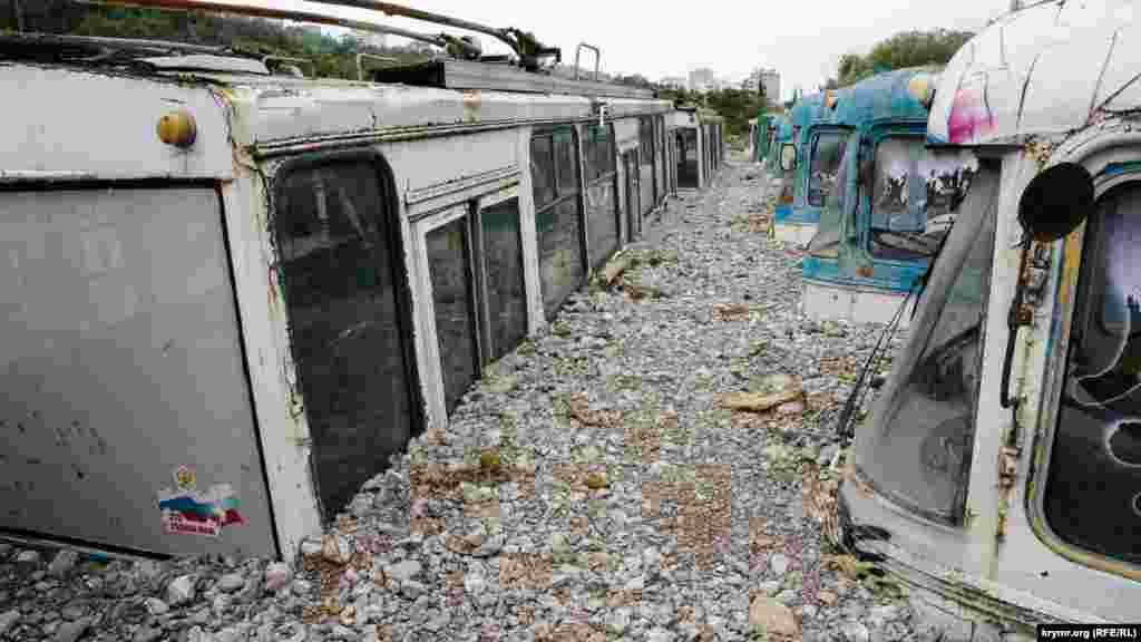 Trolleybuses swamped with stones dredged up by floodwaters in Yalta.