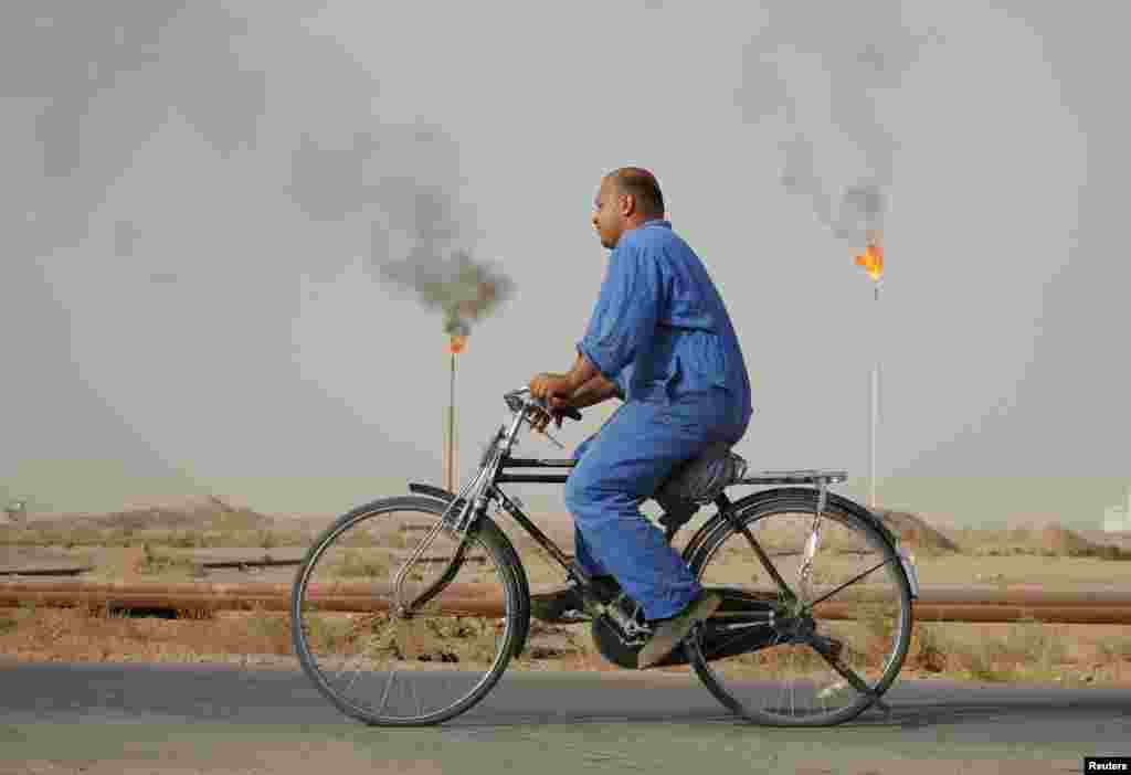 A worker rides a bicycle at a Najaf oil refinery in Iraq. (Reuters/Ahmad Mousa)