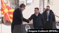 Serbian President Aleksandar Vucic (left) shakes hands with North Macedonia's prime minister, Zoran Zaev, at the Tabanovce border crossing for the ceremonial handover of some COVID-19 vaccines on February 14. 