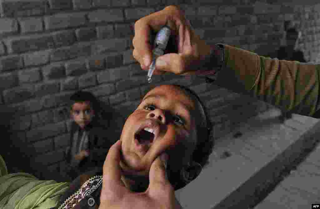 A health worker administers polio vaccine drops to a child during the second day of a vaccination campaign in Jalalabad, Afghanistan. Polio, once a worldwide scourge, is endemic in just three countries now -- Afghanistan, Nigeria, and Pakistan. (AFP/Noorullah Shirzada)