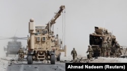 FILE: U.S. troops assess the damage after an attack in Kandahar in August 2017.