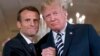 U.S. President Donald Trump (right) and French President Emmanuel Macron embrace at the conclusion of a news conference in the East Room of the White House in Washington, D.C., on April 24.
