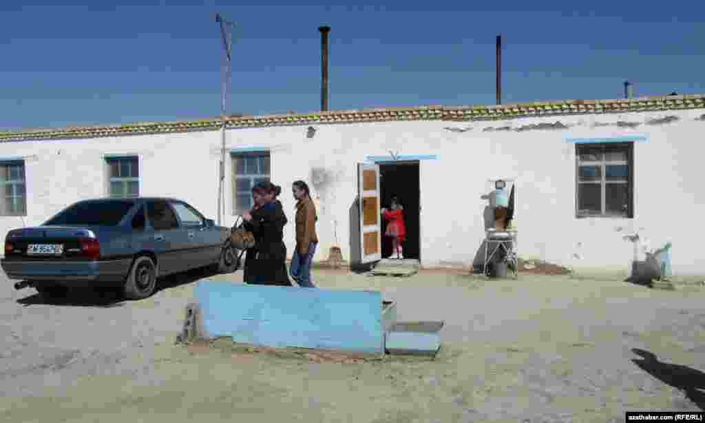 Turkmen villagers emerge from a shop.