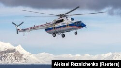 The Russian-made Mil Mi-8 helicopter that crashed on October 26 with eight people aboard off the coast of the Arctic Svalbard archipelago is shown in the settlement of Barentsburg in April 2015.