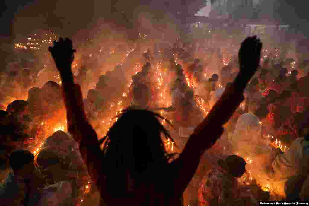 Hindu devotees sit together on the floor of a temple as part of the religious festival of Rakher Upabash in Narayangonj, Bangladesh. (Reuters/Mohammad Ponir Hossain)