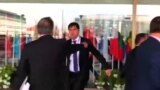 Punches Thrown As Tajik Officials, Activists Scuffle In Poland