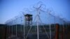 Cuba -- Chain link fence and concertina wire surrounds a deserted guard tower within Joint Task Force Guantanamo's Camp Delta at the U.S. Naval Base in Guantanamo Bay, March 21, 2016