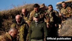 Armenian Prime Minister Nikol Pashinian (in cap) visits a section of the Line of Contact in November 2019.