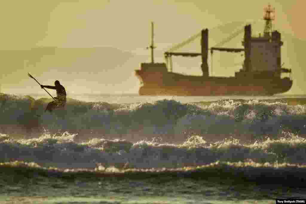 A man surfs in Ussuri Bay, near Vladivostok, Russia. (TASS/Yury Smityuk)