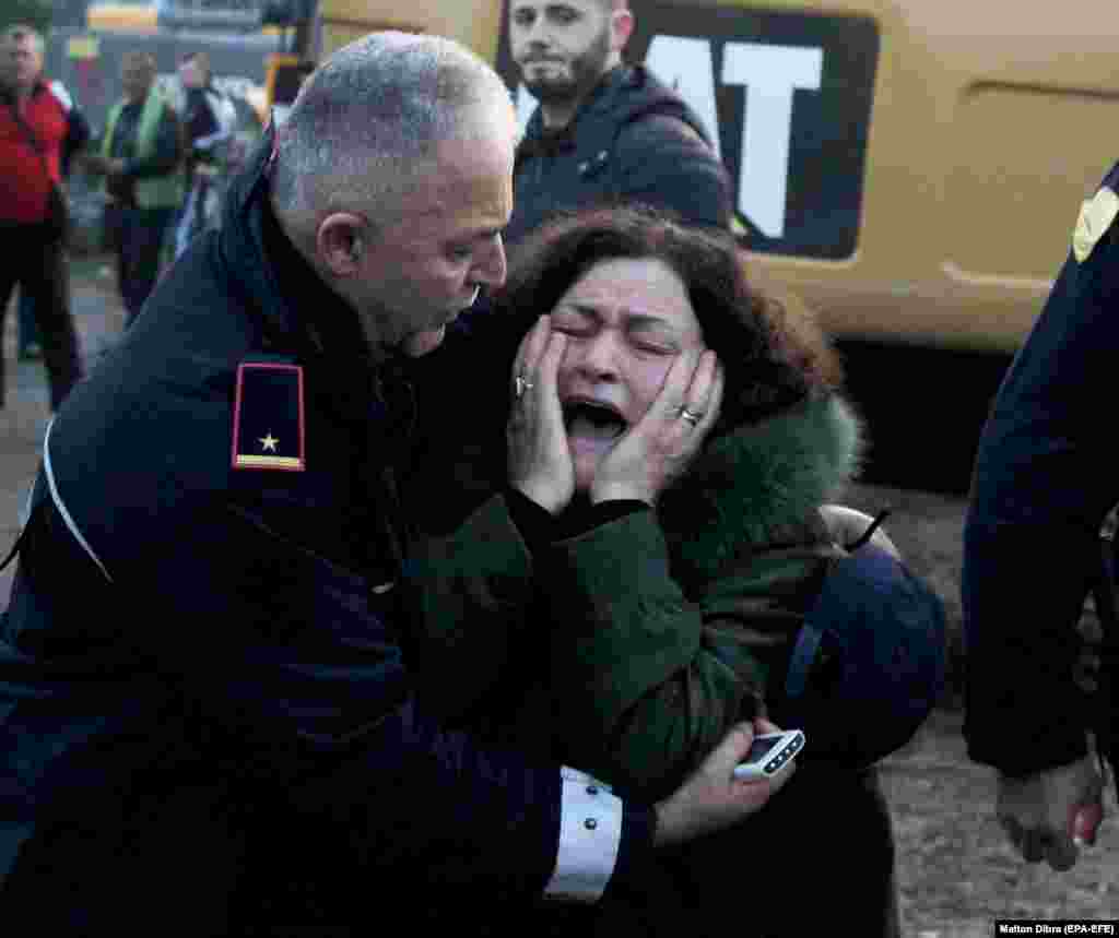 A woman cries as her relatives are trapped in a building after an earthquake hit Thumane, Albania, on November 26. (epa-EFE/Malton Dibra)