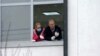 Kosovo: People watch from a window of Students Center in Prishtina, which is converted in quarantine 