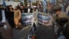 Pakistani student members of an Islamist party burn images of U.S. President Donald Trump during a protest against U.S. aid cuts in Islamabad on January 5