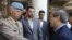Syria's Deputy Foreign Minister Faisal al-Miqdad (right) greets Major General Robert Mood, chief of the United Nations Supervision Mission in Syria, in Damascus on June 5.