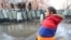 Armenia -- An opposition protester stands against the backdrop of riot police protecting the main Armenian government building in Yerevan, December 24, 2020.