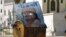 Libya -- A poster of Muammar Qaddafi sits in a garbage container in a deserted street in Tripoli, 30Aug2011