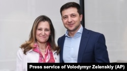 Ukrainian President-elect Volodymyr Zelenskiy (right) poses for a photo with Chrystia Freeland, then Canada's foreign minister, during a meeting in Kyiv in May 2019.