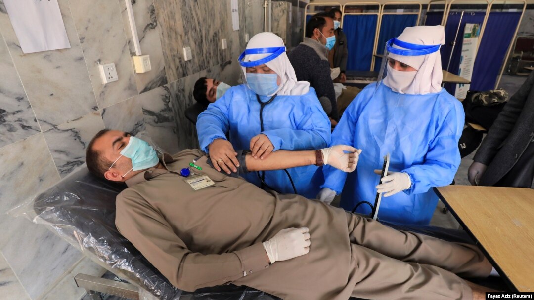 A health workers undergoes a medical checkup after receiving a dose of Sinopharm's coronavirus vaccine, donated by China, at a vaccination center in Peshawar on February 3.