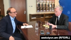 U.S. national-security adviser John Bolton (right) speaks with RFE/RL's Harry Tamrazian in Yerevan on October 25.