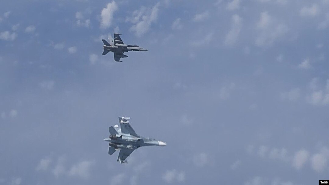 A video grab from the Russian Defense Ministry, which the ministry said shows a NATO F-18 jet (above) and a Russian Su-27 jet over the Baltic Sea.