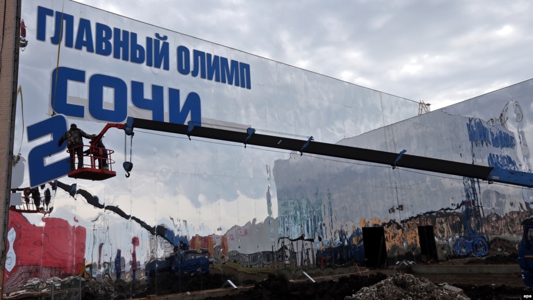 Workers prepare a building of the Olympic Main Store at the Olympic Park in Sochi on January 27, less than two weeks before the Opening Ceremony.