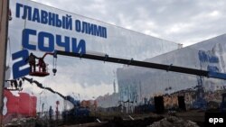 Workers prepare a building of the Olympic Main Store at the Olympic Park in Sochi on January 27, less than two weeks before the Opening Ceremony.