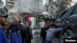 Rescuers work at the site of an air strike on the Iranian Consulate in Damascus on April 1. 