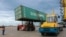 KAZAKHSTAN -- Workers load a shipping crate in the Kazakhstan's Caspian seaport of Aktau, August 14, 2018