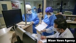 Doctors and health workers dealing with coronavirus crisis in Qom, Iran. March 10, 2020