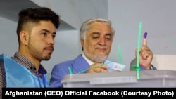 Candidate Abdullah Abdullah casts his vote in a voting center in Kabul. Both candidates immediately declared victory.