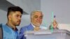 Abdullah Abdullah (L) casts his vote in a polling center in Kabul on September 28.