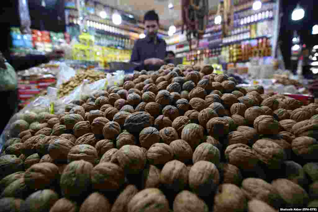 A man sells dried nuts and fruit at his shop in Karachi, Pakistan. (epa-EFE/Shahzaib Akber)
