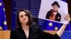 BELGIUM -- Belarusian opposition politician Svyatlana Tsikhanouskaya holds a picture of Belarusian opposition activist Nina Bahinskaya as she gives a speech during the Sakharov Prize ceremony at the European Parliament in Brussels, December 16, 2020 