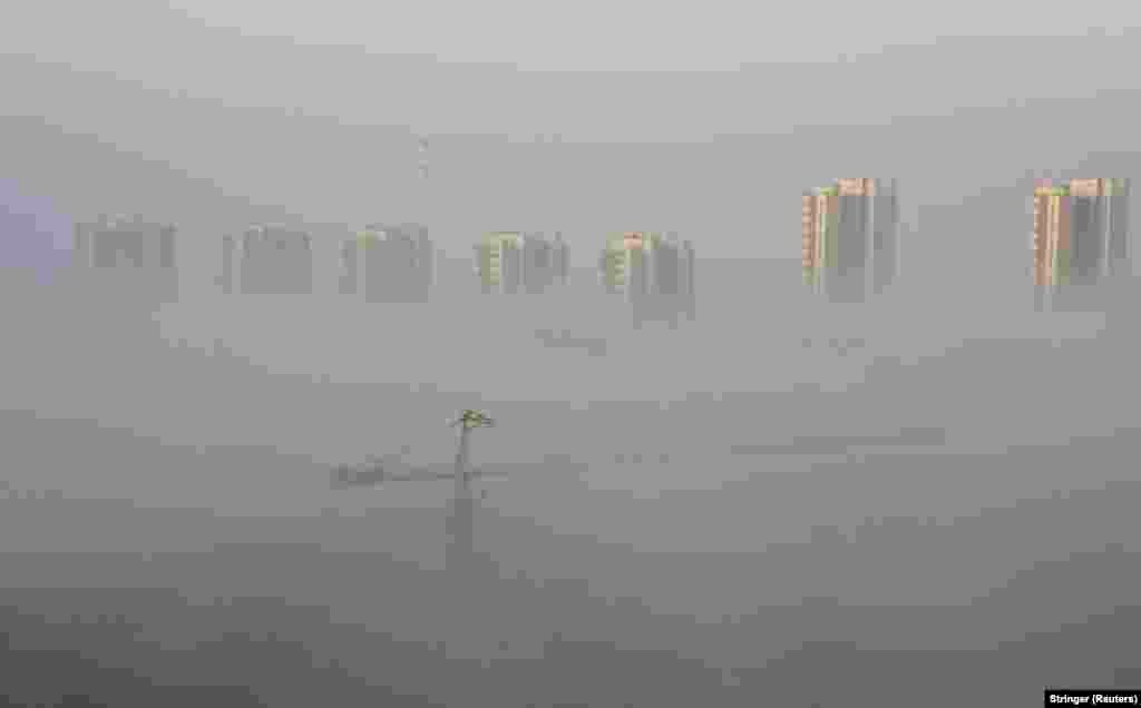 Heavy fog shrouds a construction site near a residential compound in the Chinese city of Shenyang on April 2.