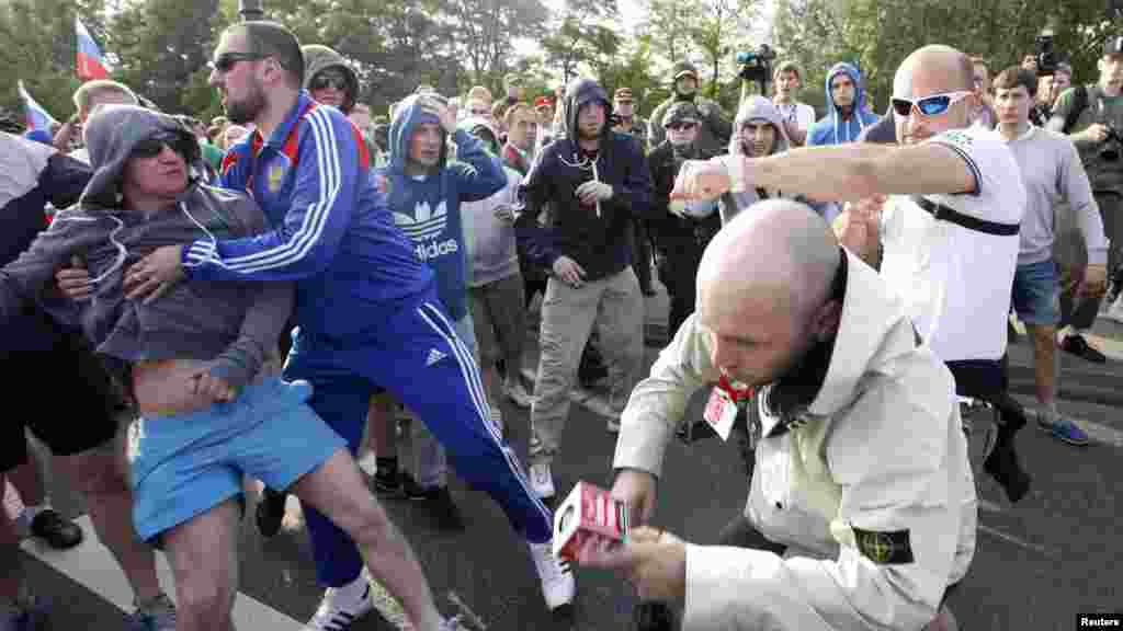 A Polish journalist (second from right) is beaten by soccer fans in Warsaw.