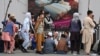 AFGHANISTAN -- Afghans queue up as they wait for the banks to open and operate at a commercial area in Kabul, August 31, 2021 - AFP