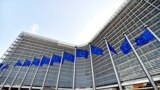BELGIUM - EU flags blown by wind in front of the European Commission Headquarters, also know as the Berlaymont building, on March 16, 2016 in Brussels