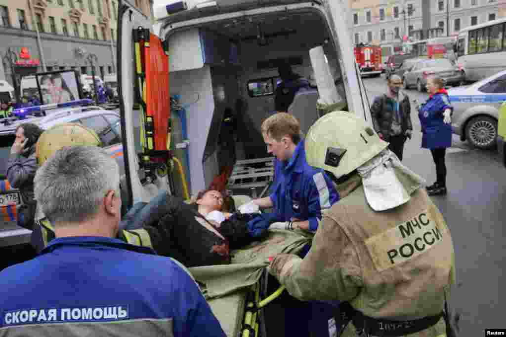 An injured person is treated outside the Sennaya Ploshchad subway station.