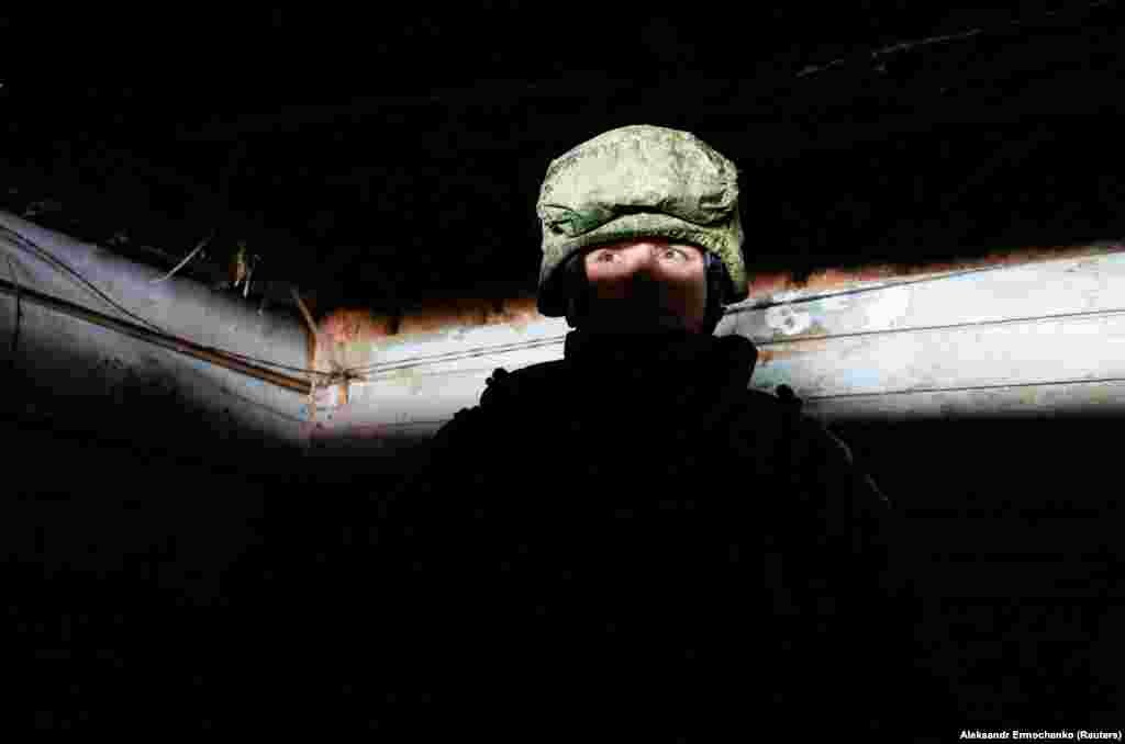 A Ukrainian separatist stands guard inside a dugout near the front line in Ukraine&#39;s eastern Donetsk Region on January 23. (Reuters/Alexander Ermochenko)