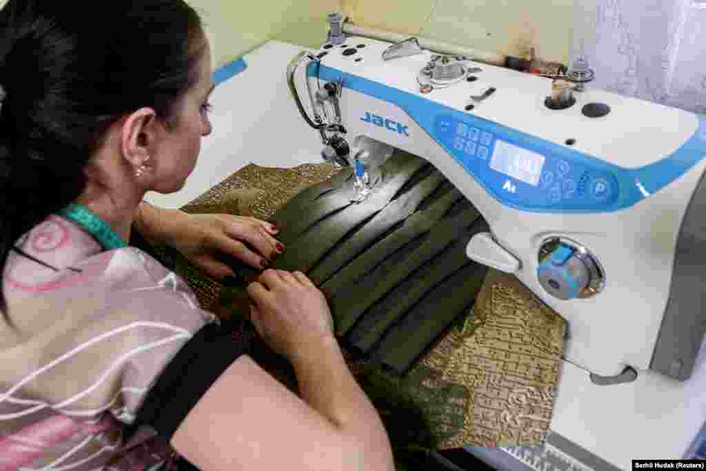 A volunteer&nbsp;in Vynohradiv makes vests that will be worn by soldiers.&nbsp;