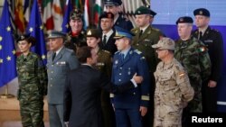 Francuski predsednik Emanuel Makron pozdravlja šefove vojnog osoblja nakon grupne fotografije posle formiranja PESCO-a (Stalna struktiralna saradnja), pakta između 25 EU vlada da finansiraju i šaju zajedno vojne snage, EU samit, Brisel, decembar 2017. 