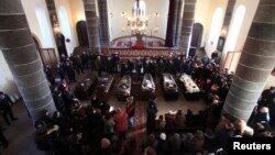 Armenia -- People surround coffins with the bodies of six murdered members of the Avetisian family during a funeral ceremony in Gyumri, January 15, 2015