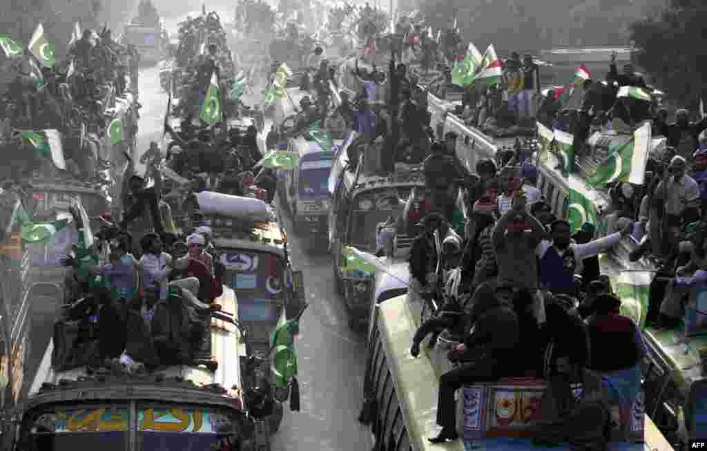 Supporters of Pakistani Islamic leader Muhammad Tahir-ul-Qadri take part in an antigovernment protest near Lahore on January 13 to demand reforms ahead of elections. 