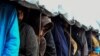 BOSNIA-HERZEGOVINA -- Illegal migrants line-up for lunch distribution at the "Vucjak" camp, on the outskirt of the city of Bihac, November 19, 2019 