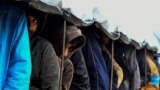 BOSNIA-HERZEGOVINA -- Illegal migrants line-up for lunch distribution at the "Vucjak" camp, on the outskirt of the city of Bihac, November 19, 2019 