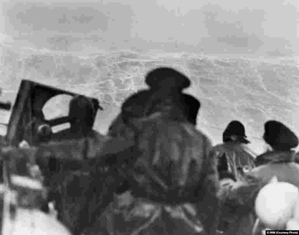 The view from the bridge of the Royal Navy cruiser "HMS Sheffield" as she battles heavy seas while escorting a convoy to Russia in February 1943.