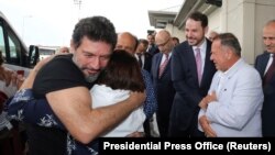 TURKEY -- Mehmet Hakan Atilla, an executive from state-controlled Halkbank, is welcomed by his relatives and Turkish Treasury and Finance Minister Berat Albayrak as he arrives at Istanbul International Airport in Istanbul, July 24, 2019