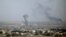 SYRIA -- Smoke rises over the Syrian town of Ras al-Ain, October 11, 2019
