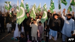 Pakistani supporters of Jamaat-ud-Dawa organisation stand on Indian and U.S. flags during a protest after leader Hafiz Saeed was placed under house arrest in Islamabad in January.