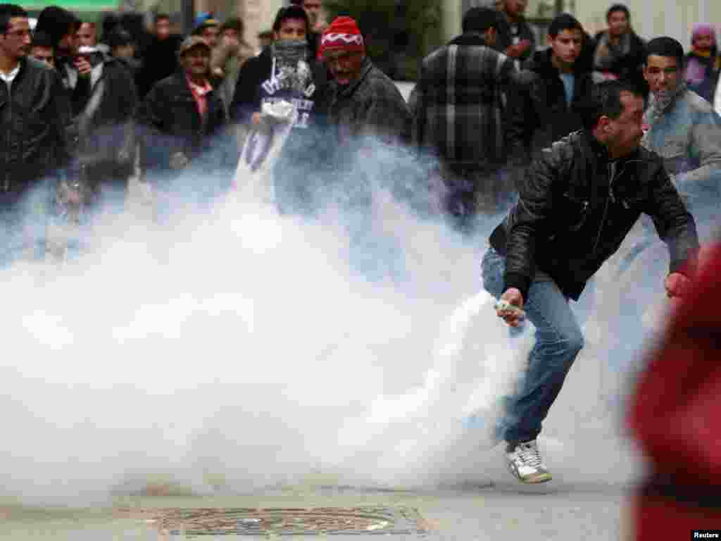 A protester throws a tear-gas canister back at riot police during a demonstration in Tunis on January 18, shortly after protests forced out longtime President Zine El Abidine Ben Ali in the first wave of the uprisings known as the Arab Spring. (Reuters/Zo