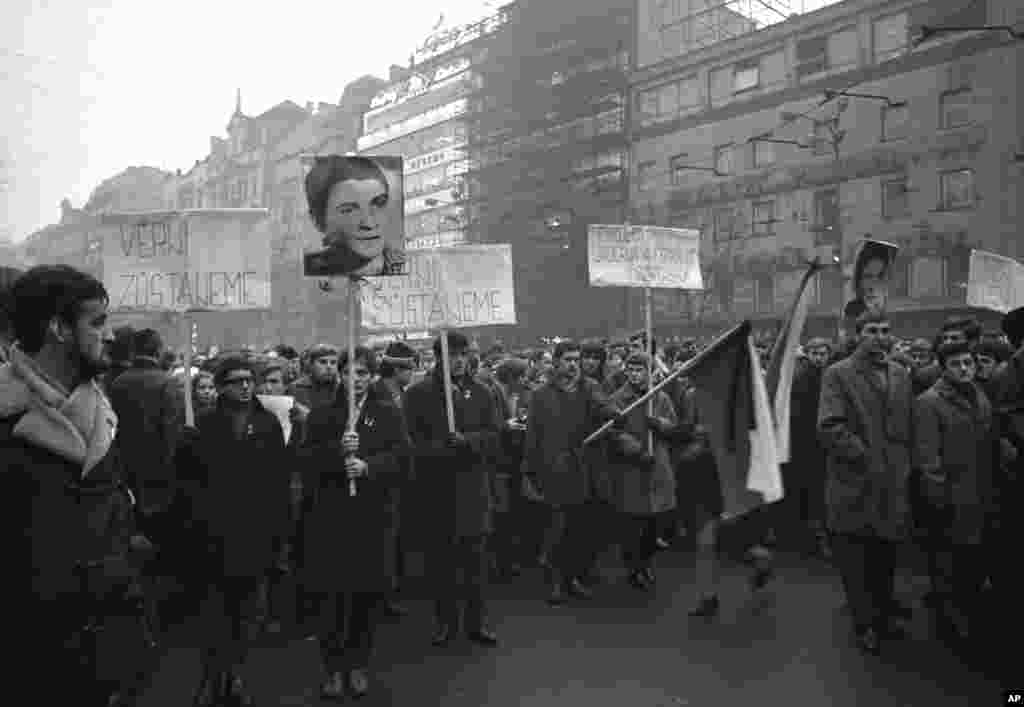 Students carry flags and a picture of Palach during a march in Prague on January 20, 1969.